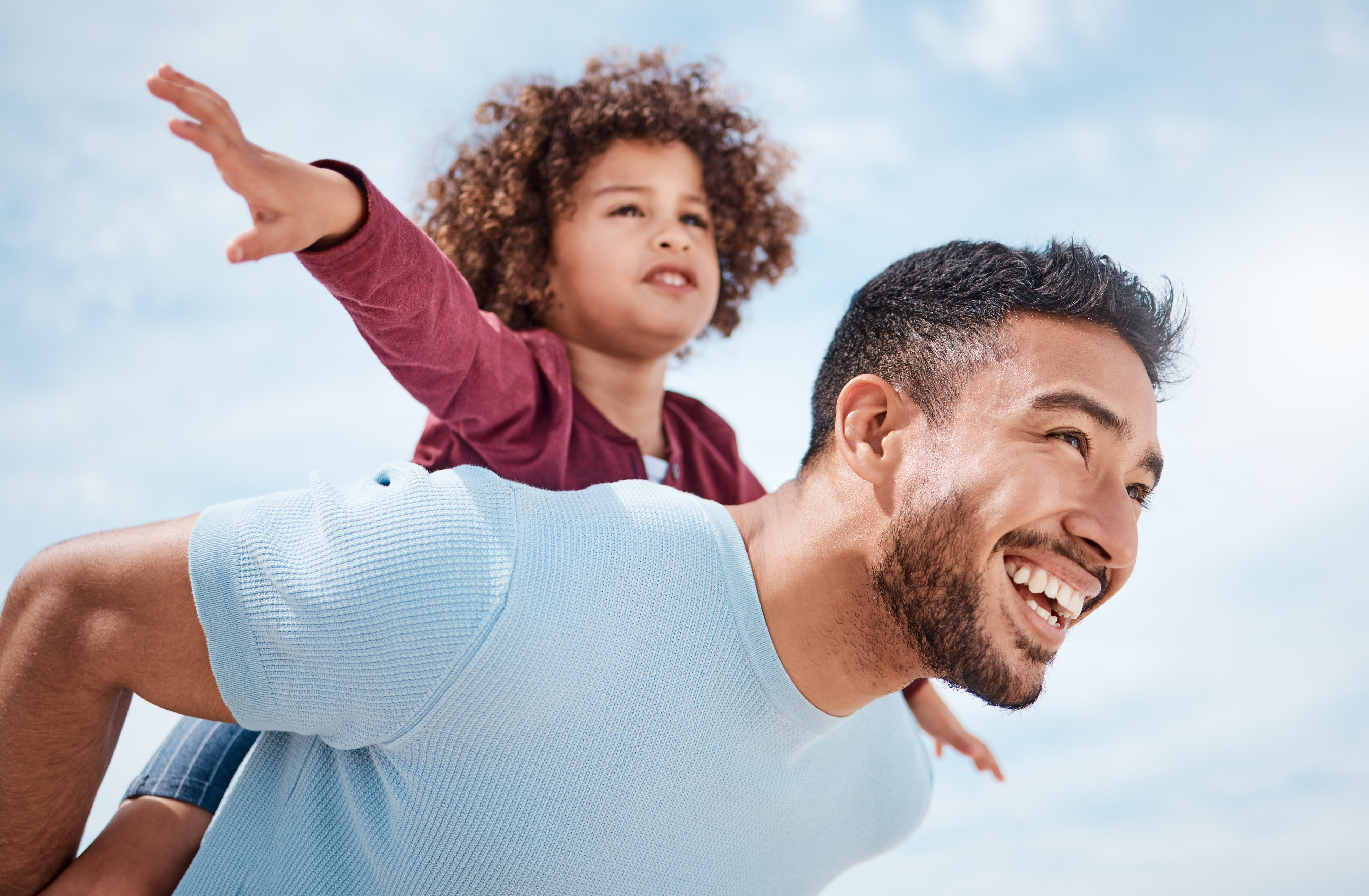 Father carrying child outdoors